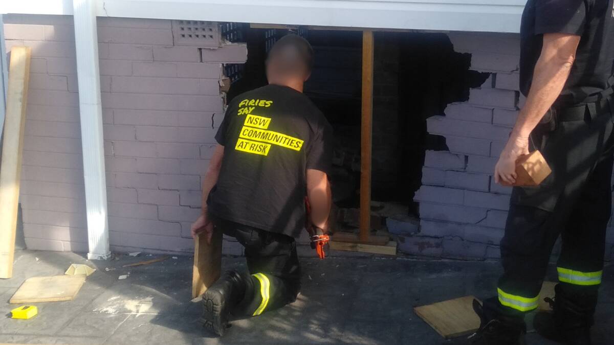 Firefighters making a temporary fix at a Barrack Heights home after an Australian Post van ran into it causing damage on April 11, 2024. Picture supplied